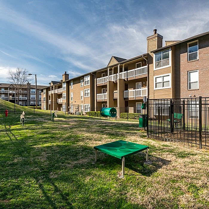 Sunlit pet-friendly apartment community with spacious balconies, lush green play area, and modern amenities.
