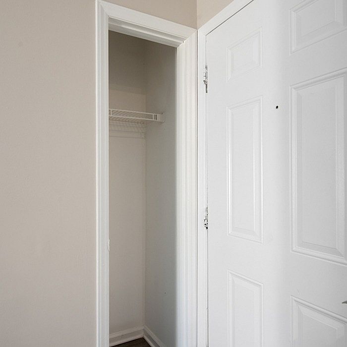 Bright and inviting entrance showcasing a sleek, modern interior closet with ample storage space.
