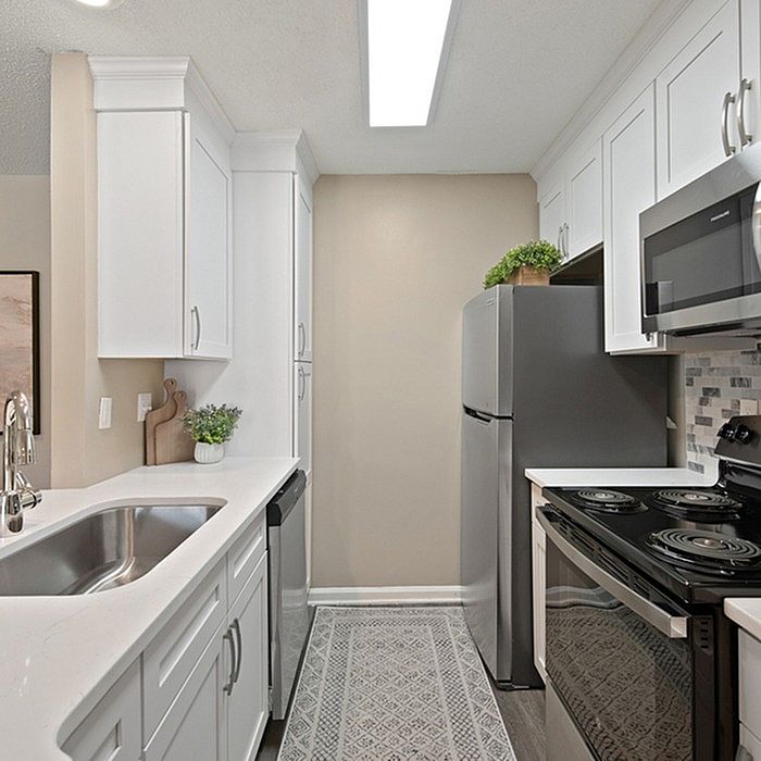 Modern kitchen with sleek stainless steel appliances, elegant cabinetry, and a stylish backsplash design.