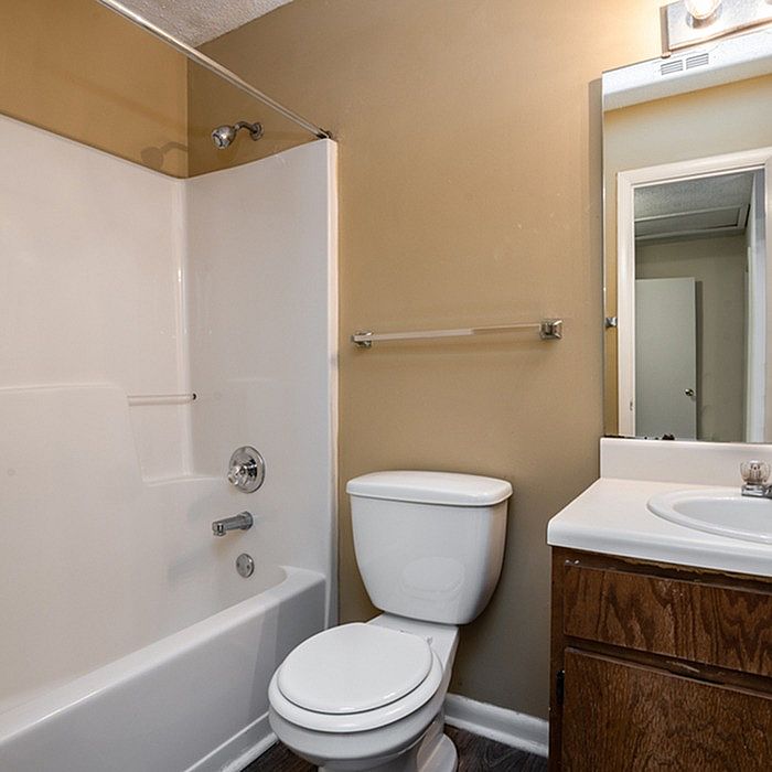 Inviting bathroom featuring a sleek bathtub, modern fixtures, and a chic vanity with ample storage.