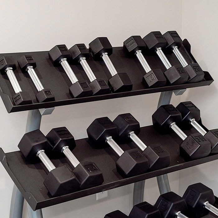 Modern fitness room feature with a sleek black rack filled with polished dumbbells, perfect for a home workout space.