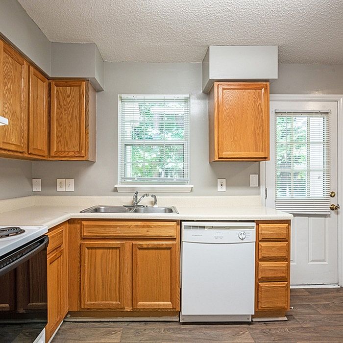 Charming kitchen with warm wooden cabinets, modern appliances, and ample natural light.