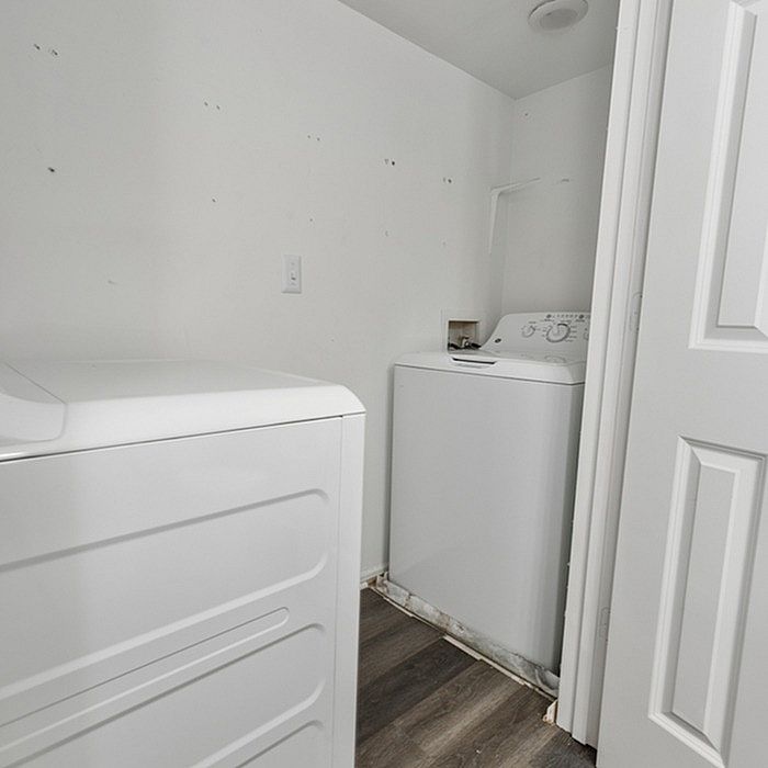 Bright and efficient laundry room featuring modern washer and dryer with sleek design and ample space.