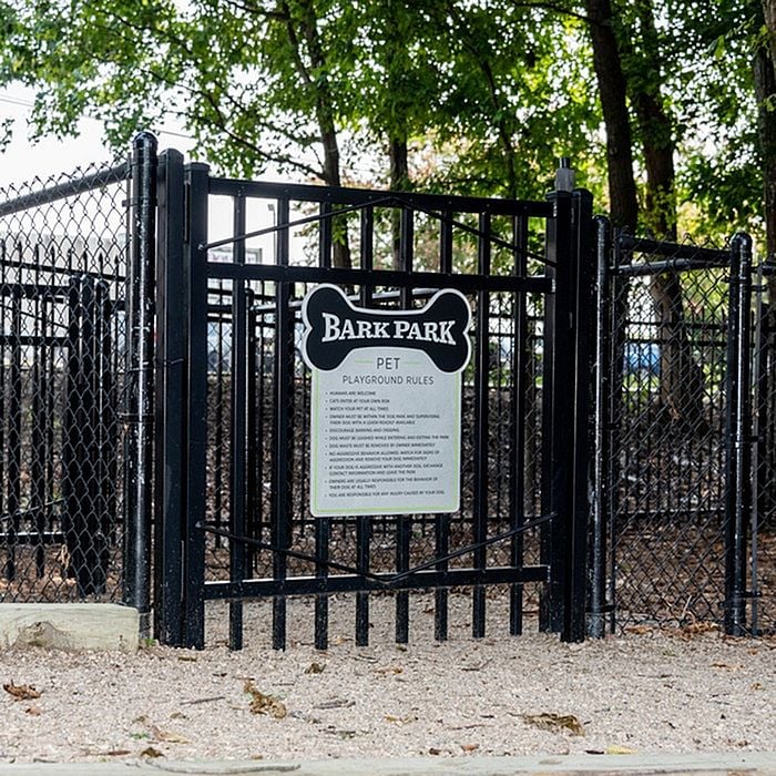 Inviting pet playground featuring a fenced Bark Park with lush greenery, ideal for pet-friendly apartment living.