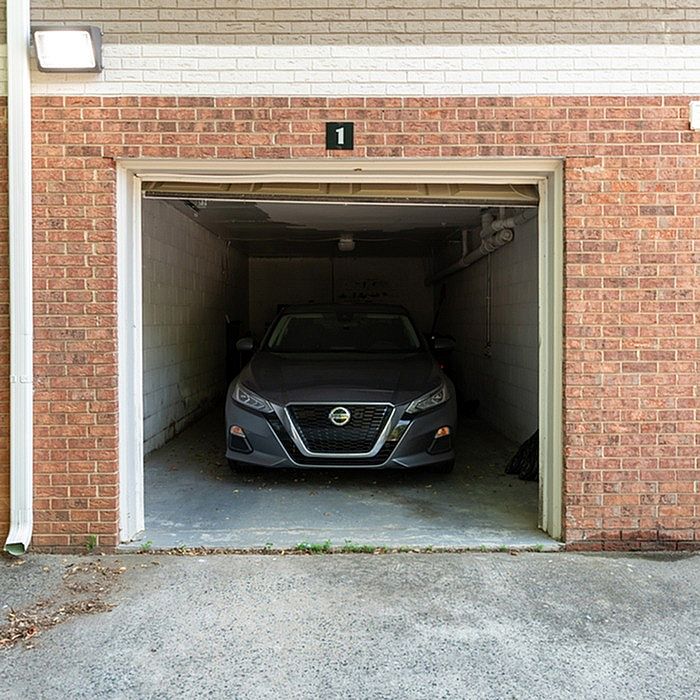 Well-maintained brick garage with a modern car, offering secure parking and added convenience.