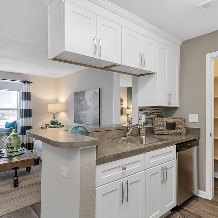 Chic open kitchen with modern cabinetry, stainless steel appliances, and inviting living room view.