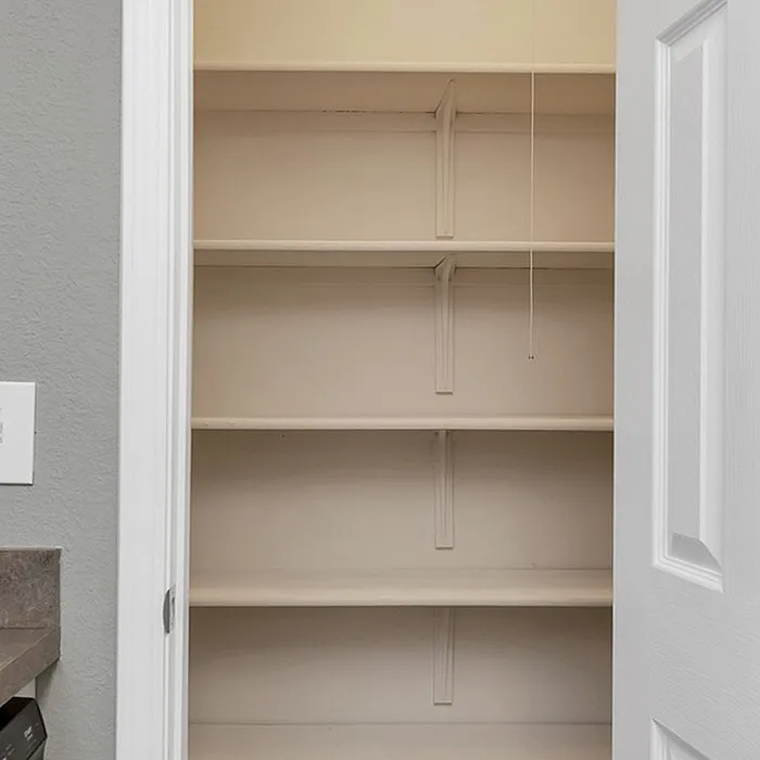 Spacious built-in pantry with multiple shelves, perfect for organized storage in a modern kitchen setup.