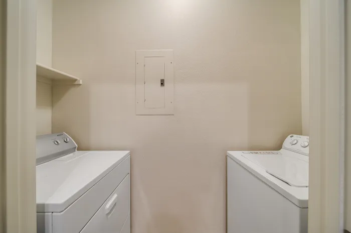 Convenient in-unit laundry room with modern washer and dryer, providing ease and efficiency for everyday living.