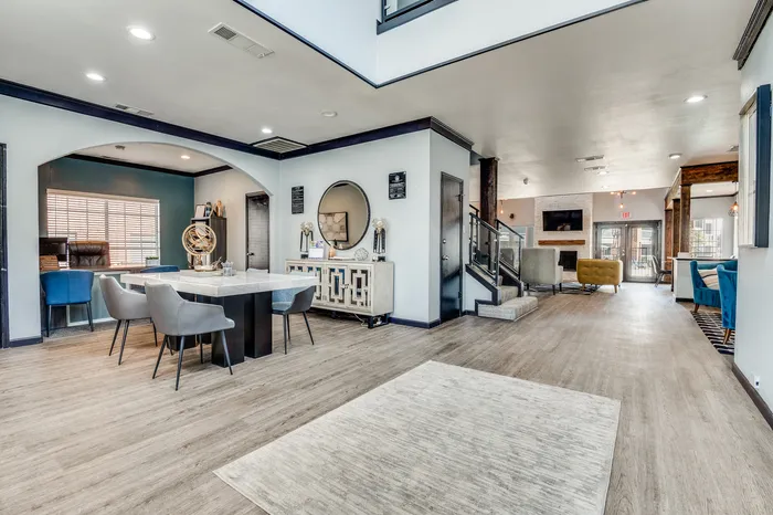 Spacious office lounge area at Preferred Place with seating, tables, and modern decor.