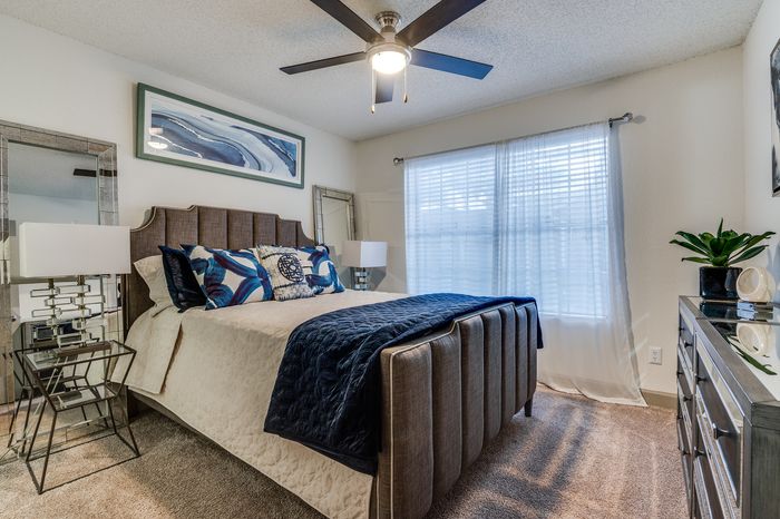 A cozy bedroom with a bed, window light, and simple d&eacute;cor creating a comfortable atmosphere.