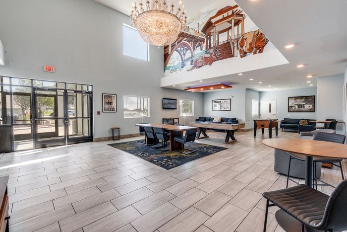 Elegant lobby at Gruene Pointe in New Braunfels, TX with a chandelier and artistic mural