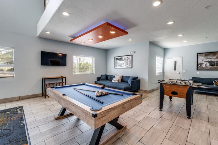 Game room at Gruene Pointe in New Braunfels, TX with a pool table and foosball