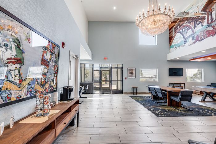 Lobby seating area at Gruene Pointe in New Braunfels, TX with modern art and a chandelier