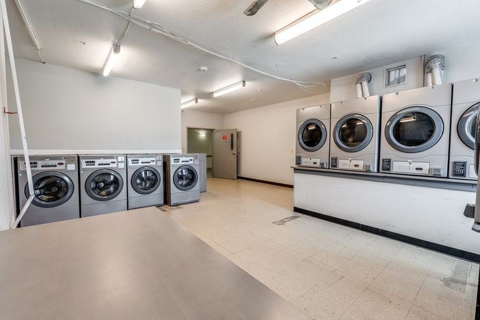On-site laundry room at Gruene Pointe in New Braunfels, TX with washers and dryers