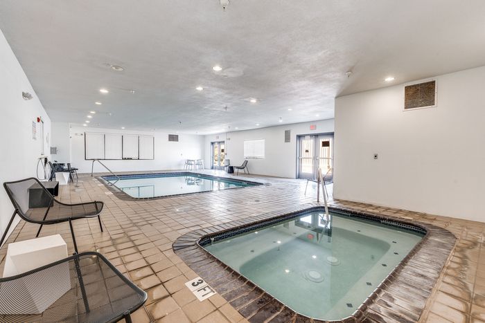 Indoor pool at Gruene Pointe in New Braunfels, TX with a hot tub and natural light