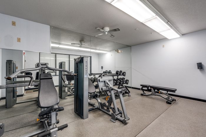 Weight room at Gruene Pointe in New Braunfels, TX with weight machines and benches