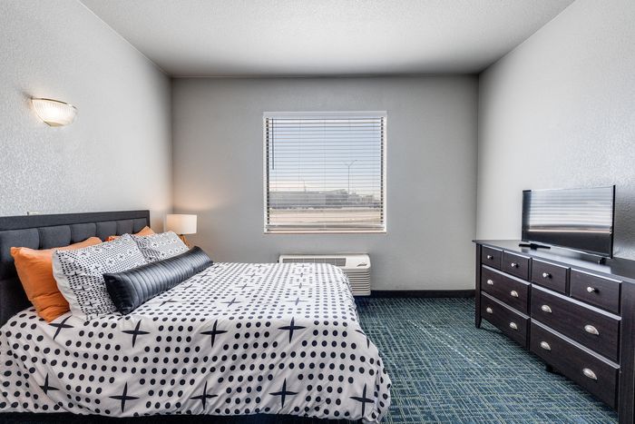 Bedroom at Gruene Pointe in New Braunfels, TX with a queen bed and sleek dresser