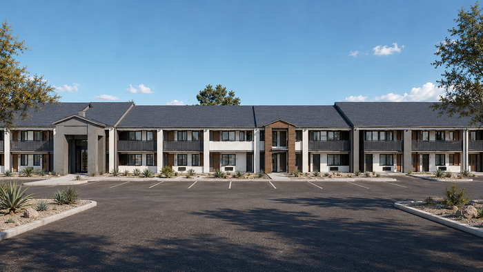 Modern two-story apartment complex with sleek design, ample parking, and manicured landscaping under a clear blue sky.