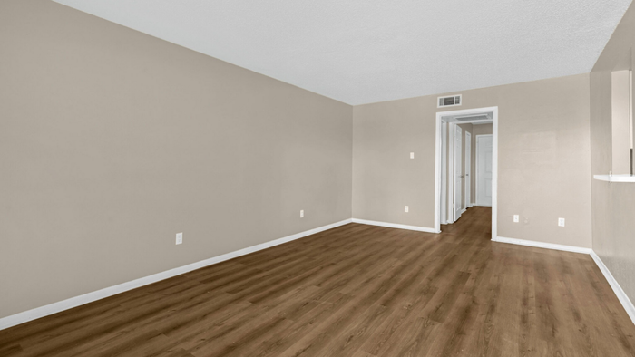 Spacious room with elegant wooden flooring and neutral tones, perfect for personalized interior design.