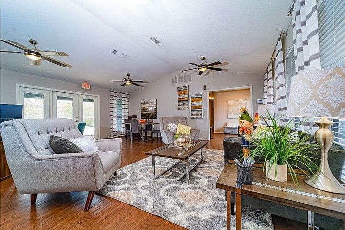 Indoor lounge with seating and ceiling fans at Dakota Apartments in Fort Worth