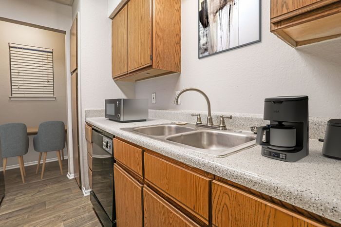 Kitchen with a coffee maker, microwave, and breakfast nook in a Dakota Apartments unit