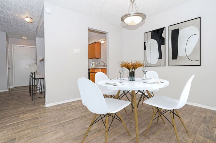 Dining area with a round table and chairs in a Dakota Apartments unit