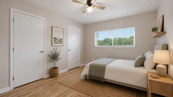 Elegant bedroom with modern decor, featuring a cozy bed, plush pillows, and a natural light-filled window view.