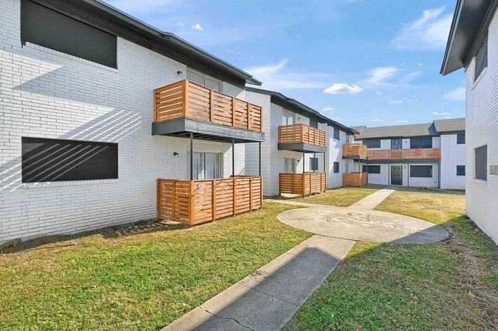 Two-story apartment building with private balconies and a courtyard at The Crawford at Denison