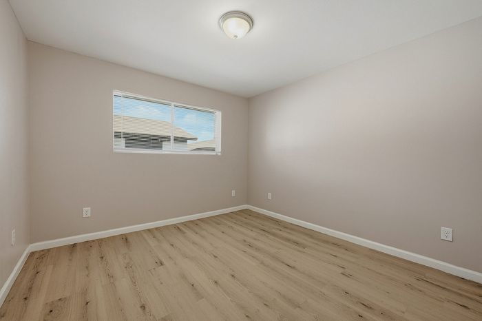 Bedroom with wood-style flooring and a large window at The Crawford at Denison