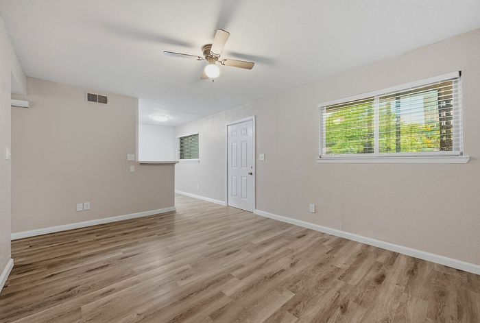 Living space with wood-style flooring and large windows at The Crawford at Denison