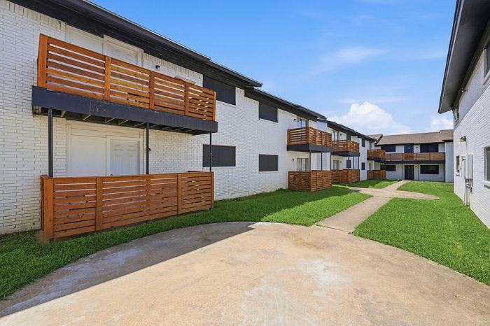 Apartment building with balconies and a green courtyard at The Crawford at Denison