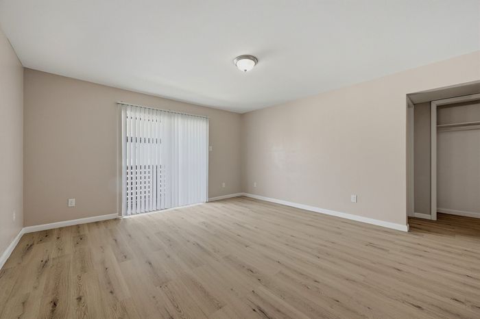 Living space with wood-style flooring and large windows at The Crawford at Denison