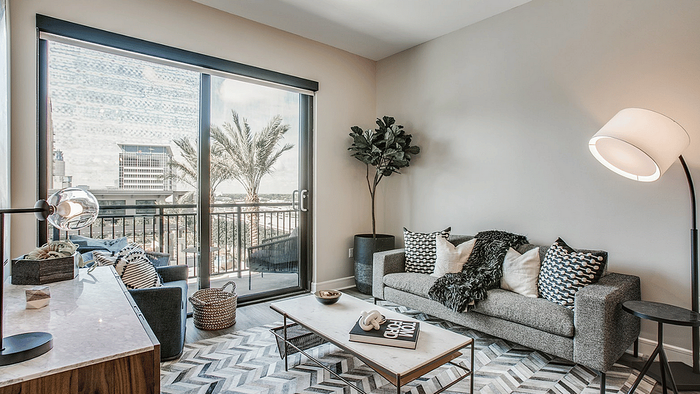 Living area with a sofa and wall art in a studio apartment at Oslo on 6th, Aurora CO