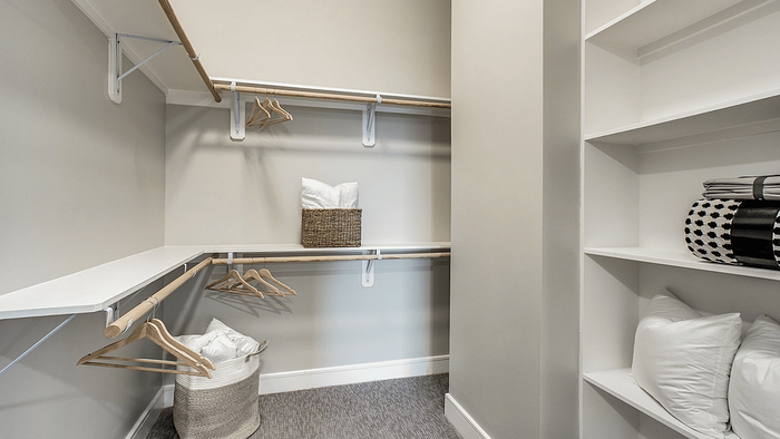 Apartment closet with a hanging rail and shelving at Oslo on 6th in Aurora, CO