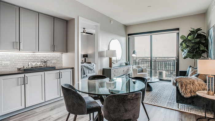 Living and dining space with a dining table in an apartment at Oslo on 6th, Aurora CO