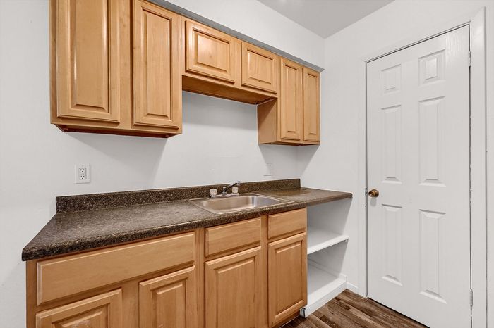 Charming kitchen with warm wood cabinetry, sleek countertops, and modern fixtures, offering a cozy and functional space.