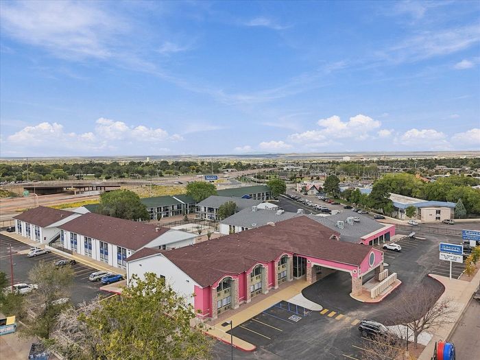 High aerial view of Juniper Flats with the main building in front and two-story residential buildings behind