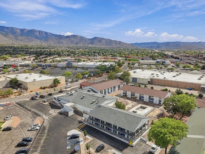 Aerial view of Juniper Flats apartment buildings and courtyard with the Sandia Mountains behind them