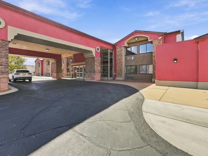 Covered drive-up main entrance with stone columns at Juniper Flats in Albuquerque, NM