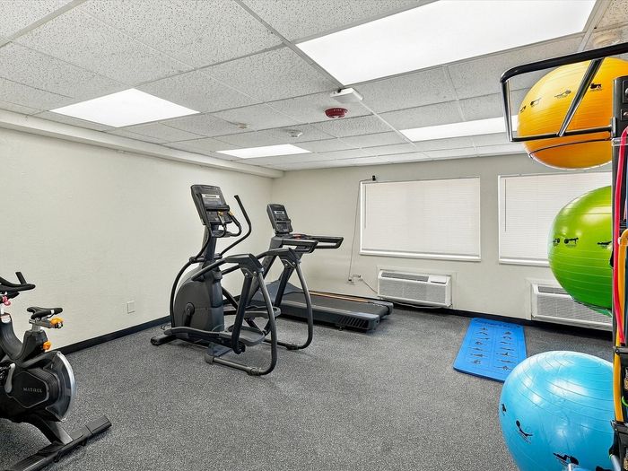 Fitness room with elliptical, treadmill, exercise bike and stability balls at Juniper Flats in Albuquerque