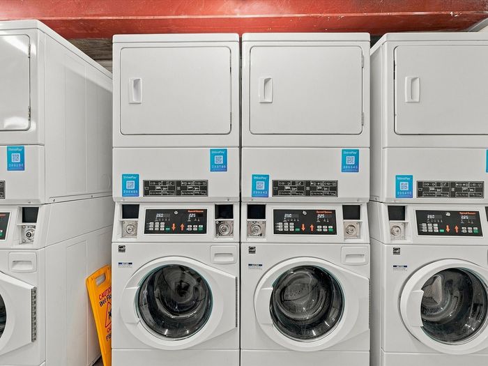Row of stacked front-load washers and dryers in the Juniper Flats laundry room in Albuquerque, NM