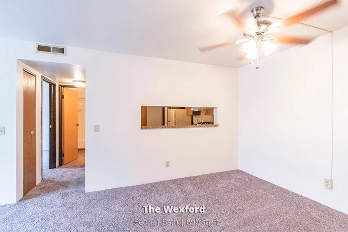 The Wexford apartment features a welcoming 1-bedroom layout with a cozy bathroom, 690 sq. ft. of stylish living space, and a peek-through kitchen design.