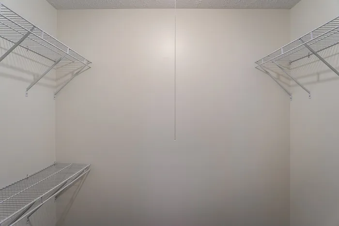 Spacious walk-in closet with ample shelving for organized storage.