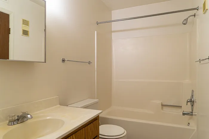 Bright and modern bathroom with sleek fixtures, spacious bathtub, and elegant vanity, exuding a clean and welcoming feel.