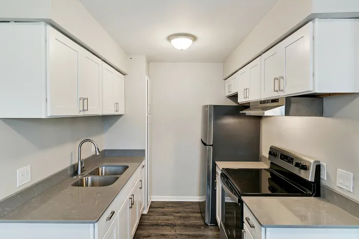 Modern kitchen featuring sleek stainless steel appliances, polished countertops, and ample cabinet space with a bright and clean design.