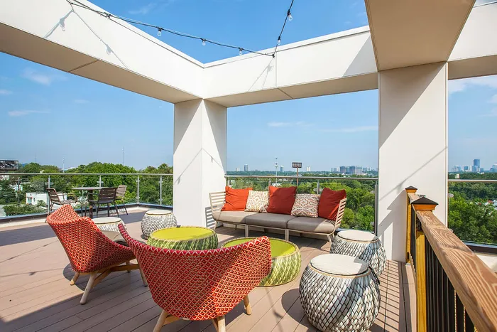 Stunning rooftop patio with cozy seating and vibrant views, perfect for relaxing or entertaining.