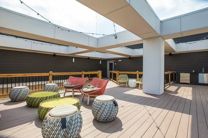 Chic rooftop terrace with stylish seating, modern design, and ample natural light.