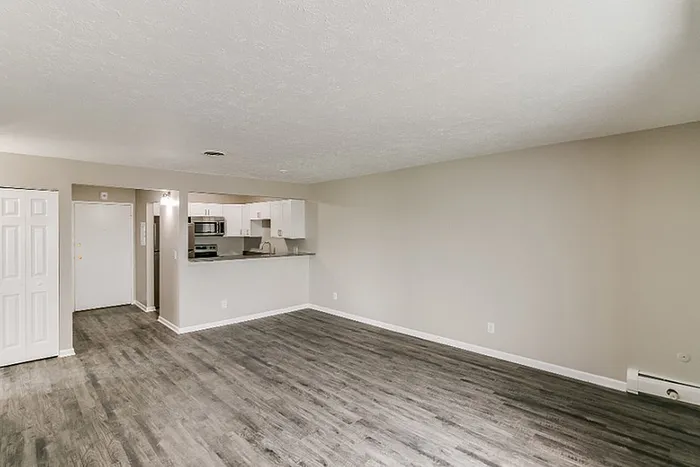 Spacious open-concept living area with modern kitchen, sleek floors, and neutral tones for a contemporary feel.