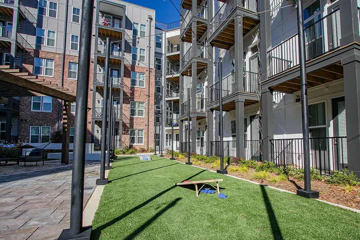 Modern apartment complex offering vibrant outdoor living spaces with lush greenery and inviting balconies.