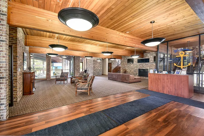 Welcoming lobby with stylish wooden ceiling, modern lighting, and comfortable seating at Harbor Point Estates.